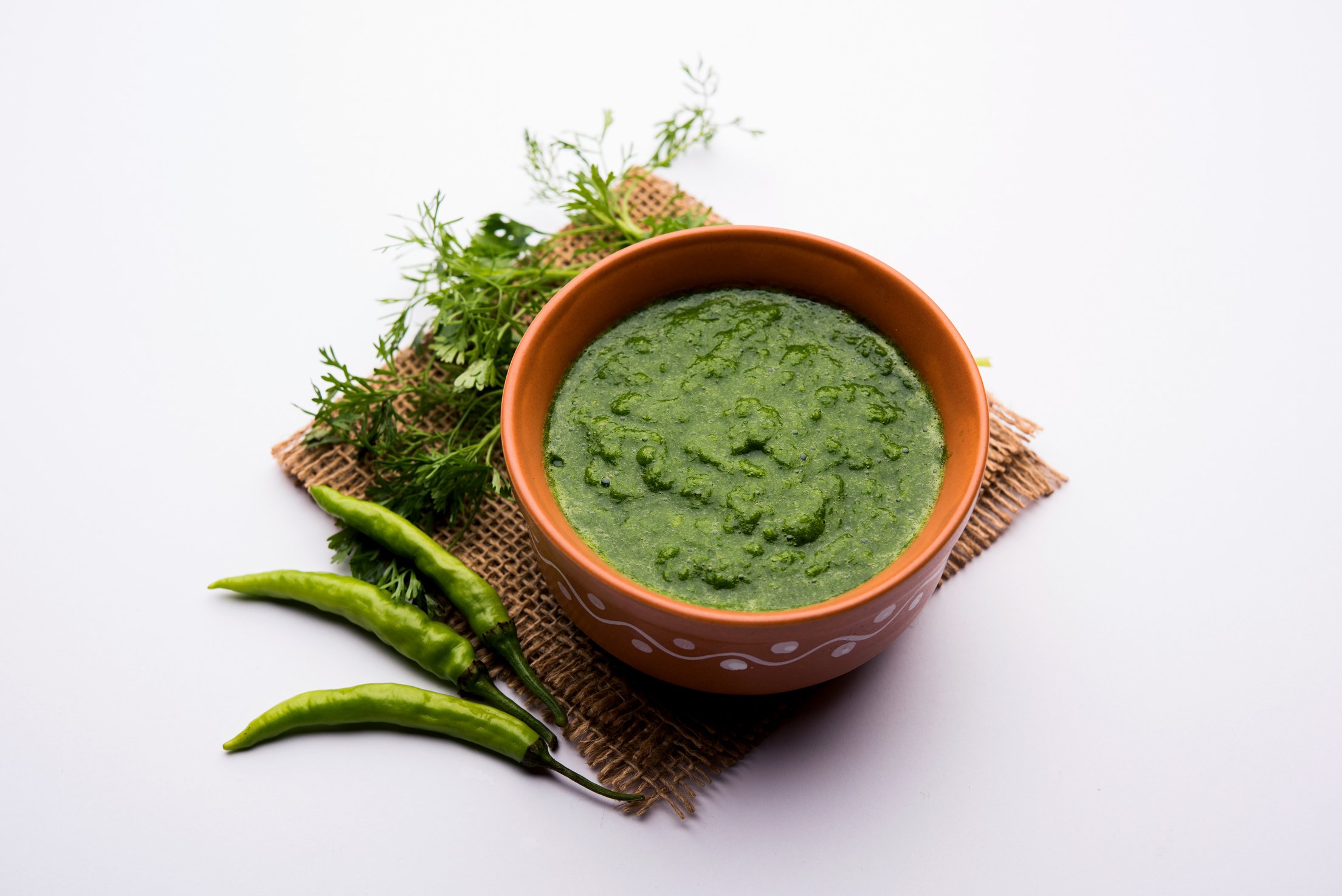 Kothimbir or Dhaniya Chutney made using Cilantro or coriander with chilli, served in a bowl. selective focus